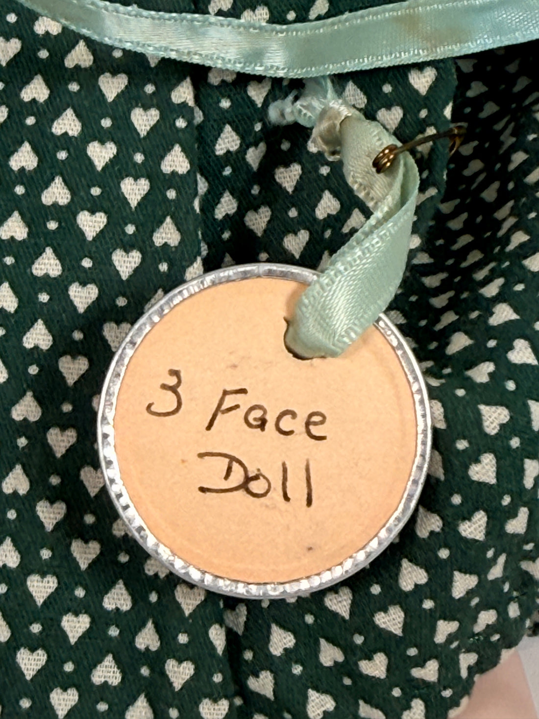 Vintage 1994 three-face baby doll with rotating expressions, lace dress, and novelty design. Rare collectible doll for vintage toy and decor collectors.