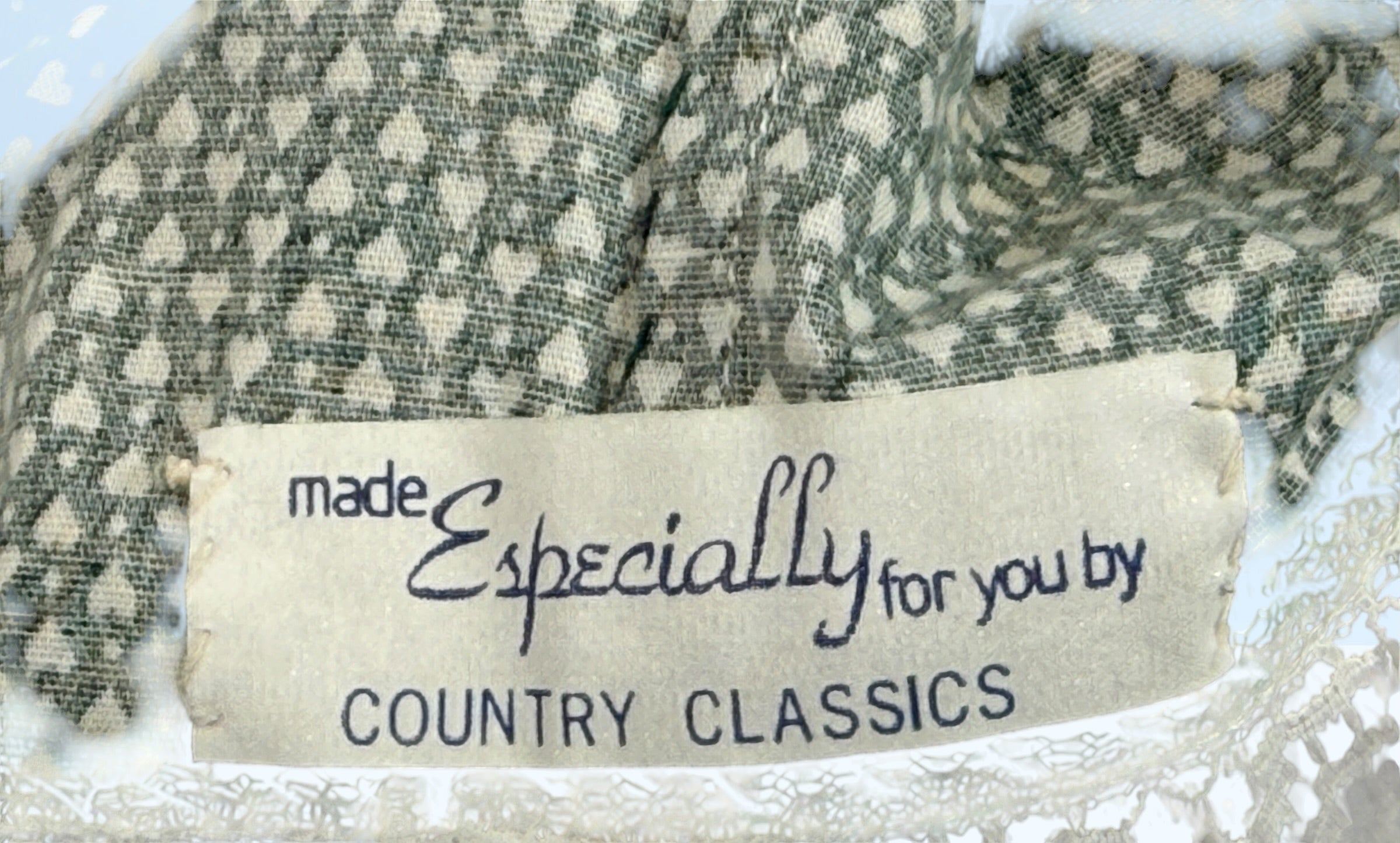 Textile with a label reading 'made Especially for you by Country Classics' on a textured background.