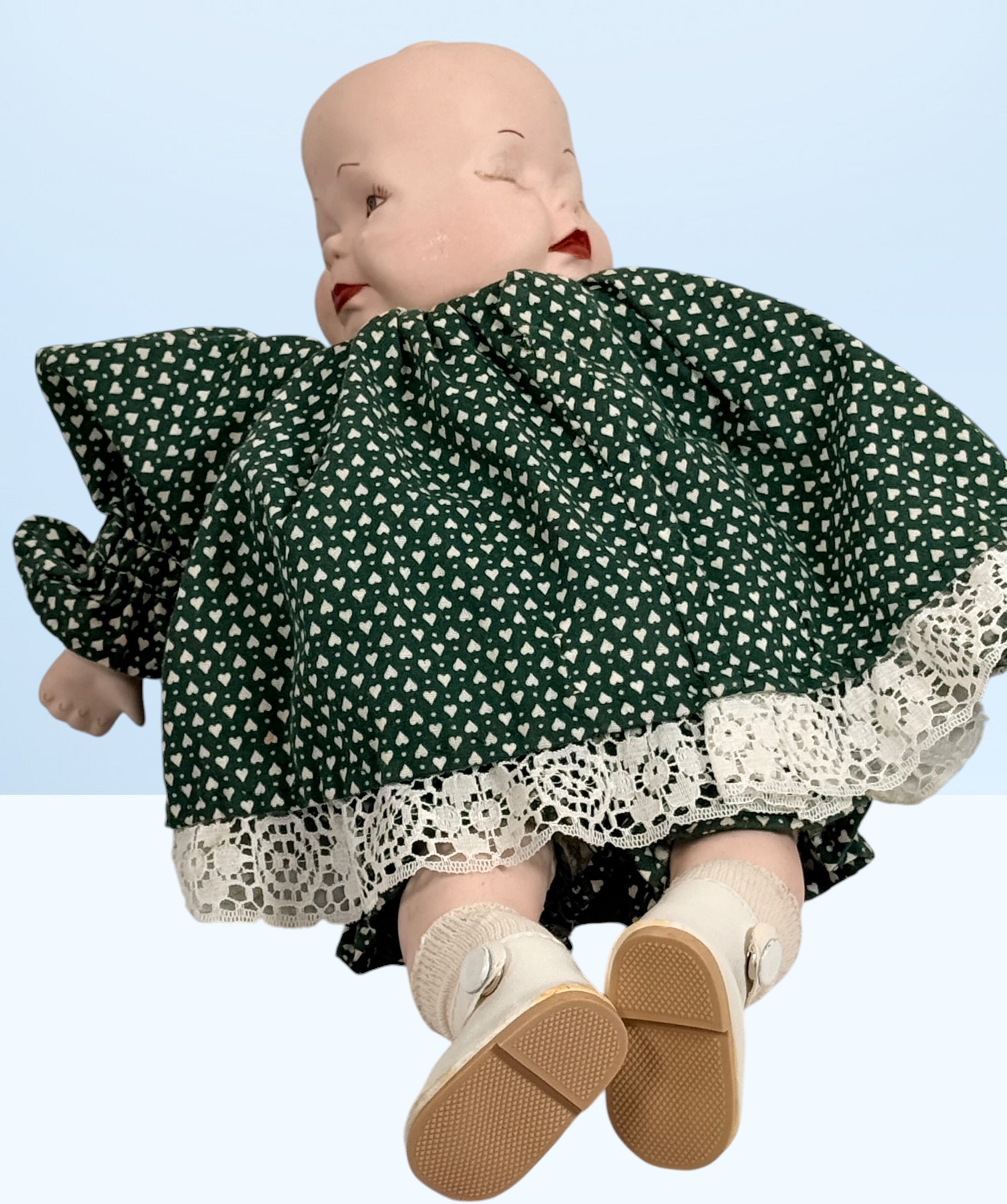 Vintage 1994 three-face baby doll with rotating expressions, lace dress, and novelty design. Rare collectible doll for vintage toy and decor collectors.