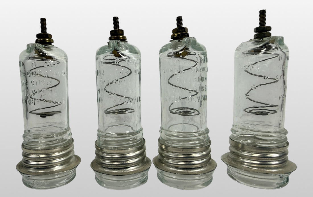Vintage neon sign glass insulator housing set of 4 marked 7500V and #200. Rare industrial electrical components with internal coils and steampunk decor appeal.