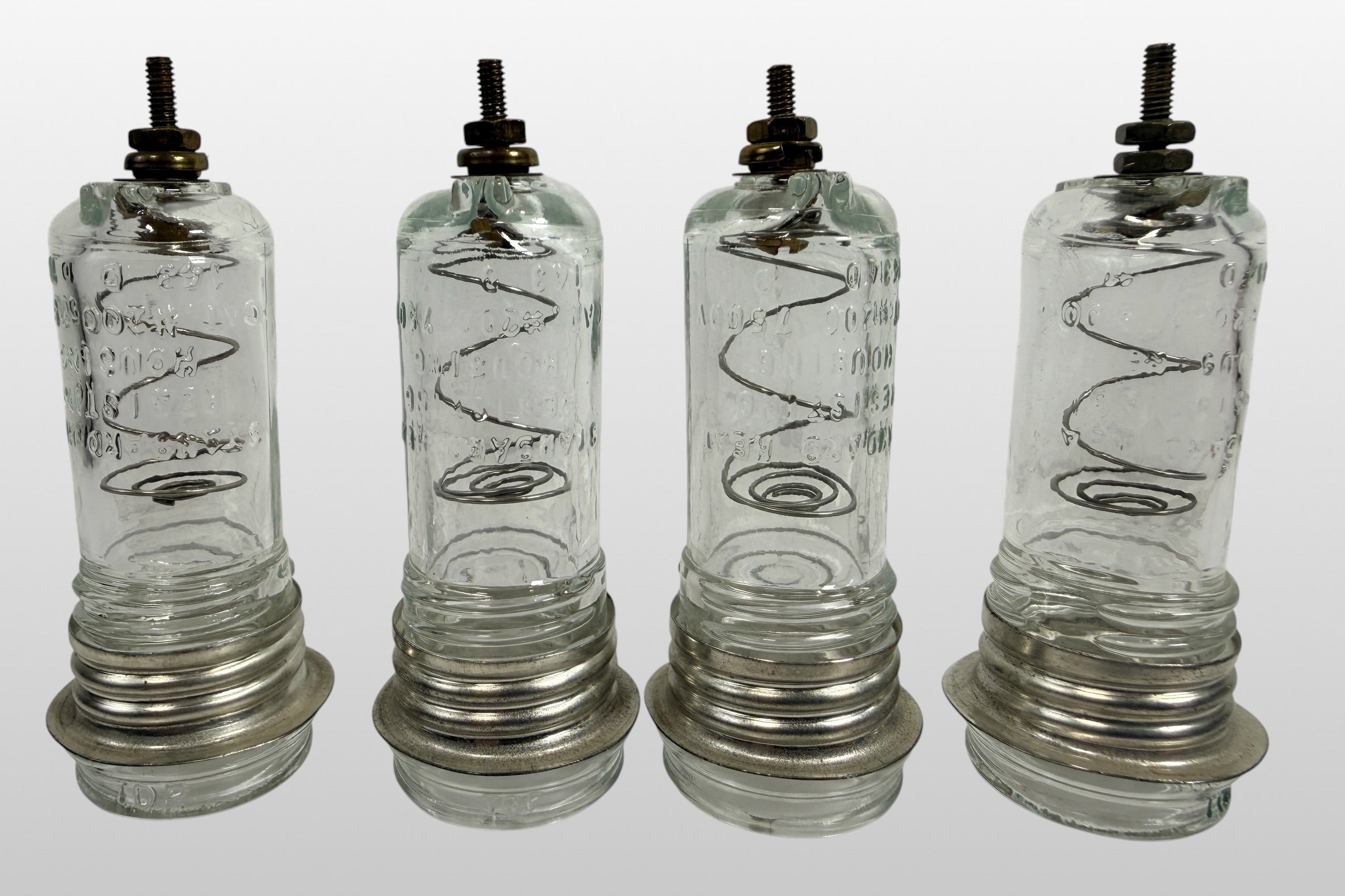 Vintage neon sign glass insulator housing set of 4 marked 7500V and #200. Rare industrial electrical components with internal coils and steampunk decor appeal.