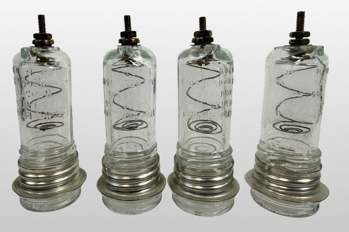 Vintage neon sign glass insulator housing set of 4 marked 7500V and #200. Rare industrial electrical components with internal coils and steampunk decor appeal.