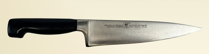 Vintage Zwilling Henckels 8” Friodur chef knife made in Solingen Germany with stainless steel blade and classic ergonomic handle.