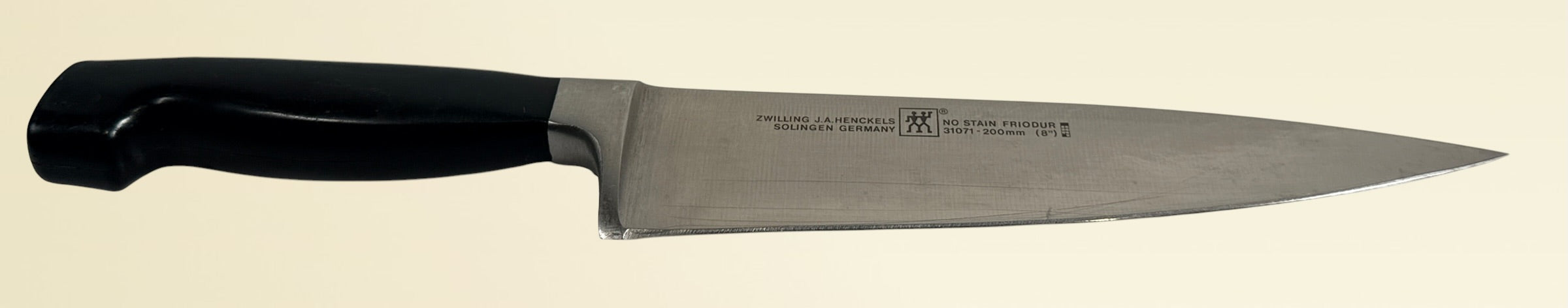 Vintage Zwilling Henckels 8” Friodur chef knife made in Solingen Germany with stainless steel blade and classic ergonomic handle.