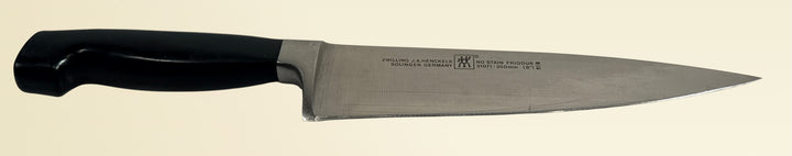 Vintage Zwilling Henckels 8” Friodur chef knife made in Solingen Germany with stainless steel blade and classic ergonomic handle.