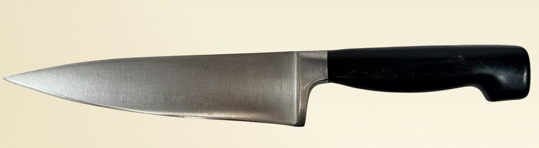 Vintage Zwilling Henckels 8” Friodur chef knife made in Solingen Germany with stainless steel blade and classic ergonomic handle.