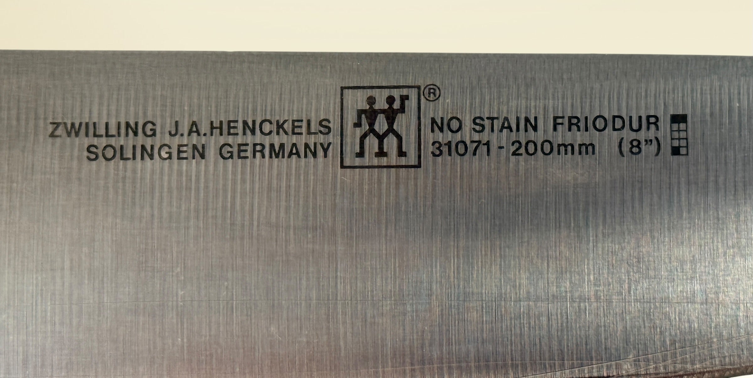Vintage Zwilling Henckels 8” Friodur chef knife made in Solingen Germany with stainless steel blade and classic ergonomic handle.
