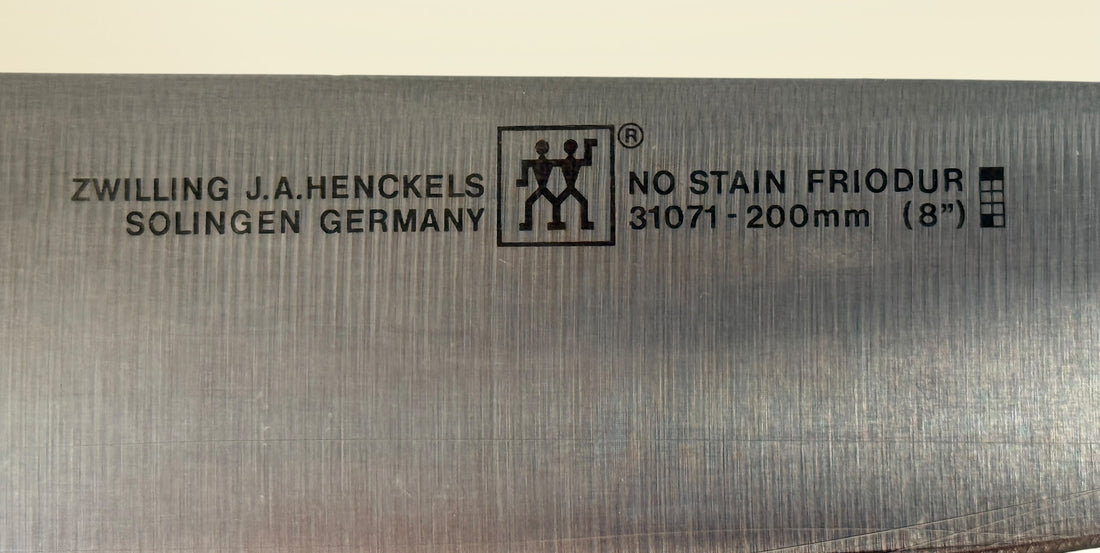 Vintage Zwilling Henckels 8” Friodur chef knife made in Solingen Germany with stainless steel blade and classic ergonomic handle.