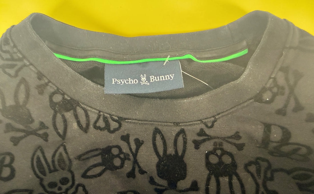 Psycho Bunny skull logo sweatshirt in charcoal grey with all-over flocked graphic print and slim modern streetwear fit.