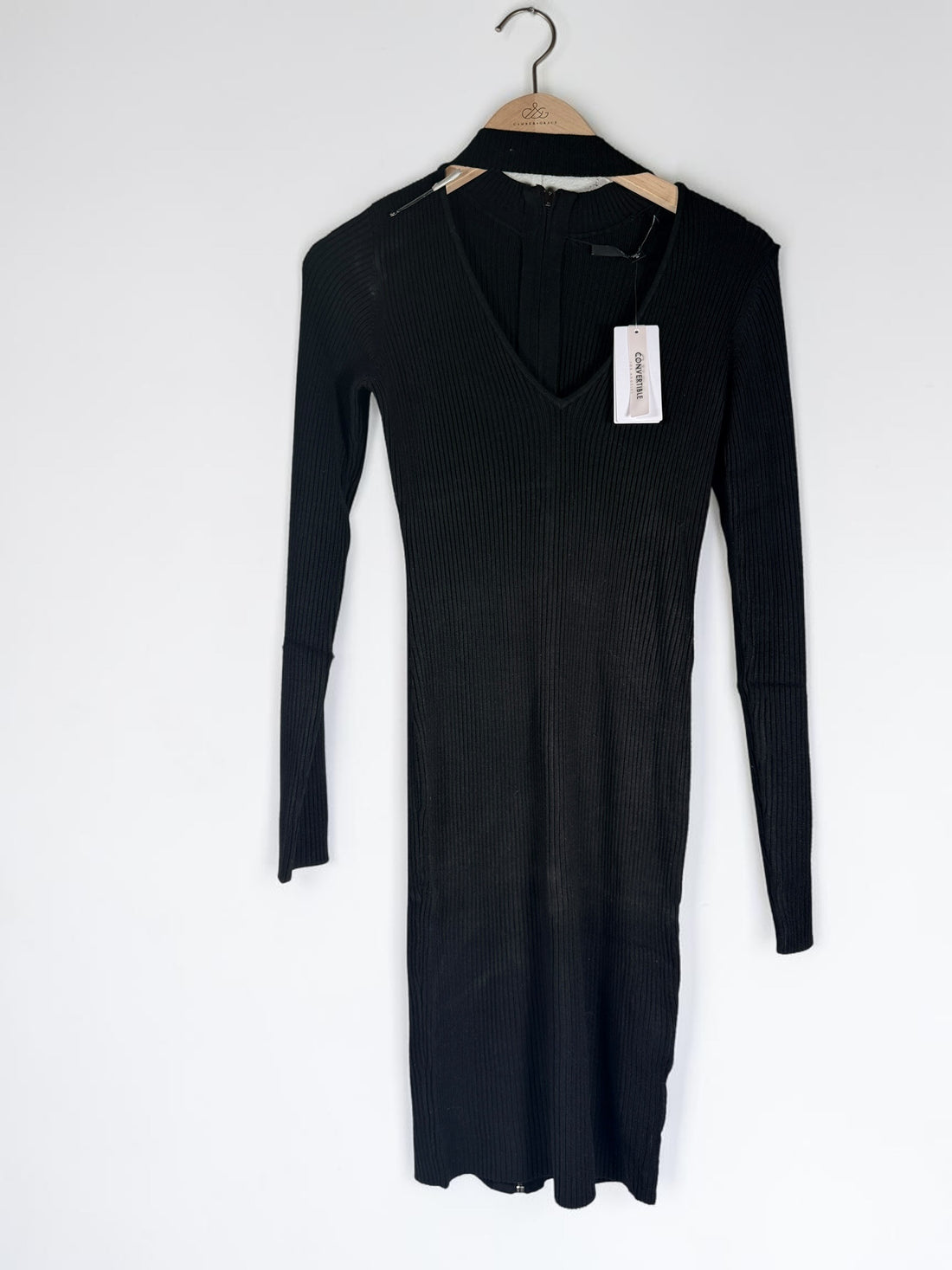 GUESS black ribbed knit bodycon dress in size medium, new with tags featuring convertible mock neck and zipper detail.