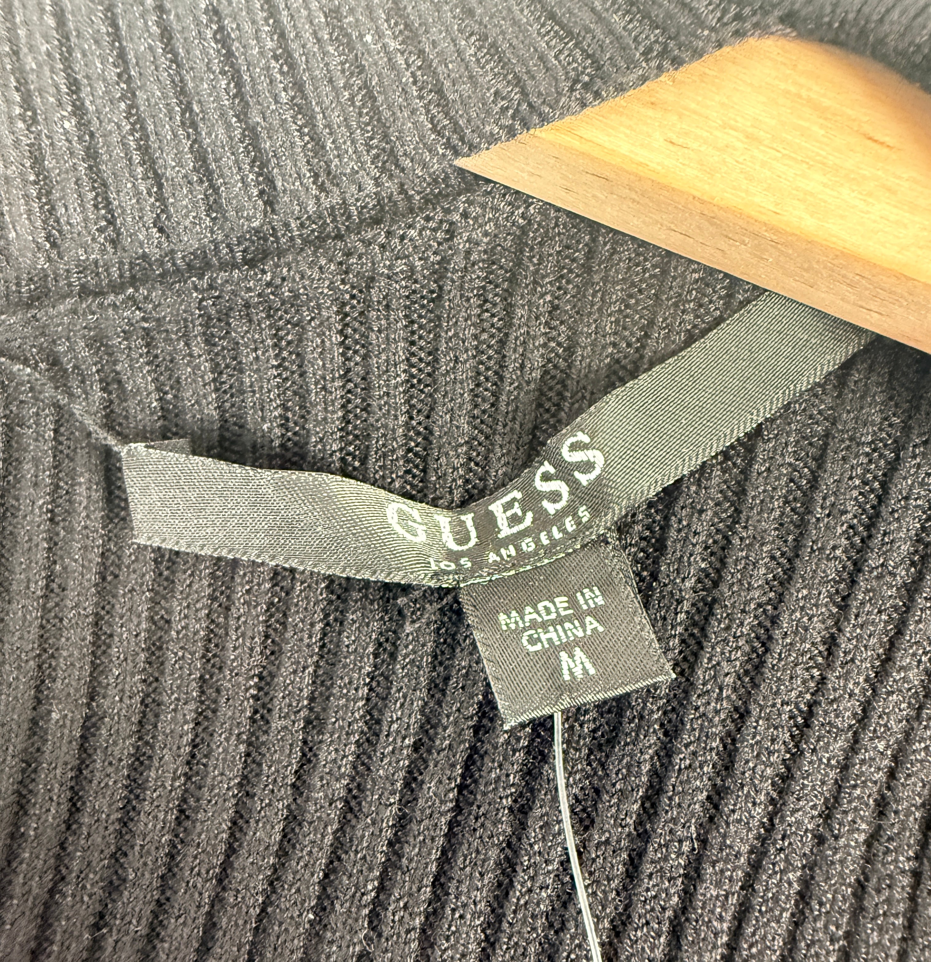 GUESS black ribbed knit bodycon dress in size medium, new with tags featuring convertible mock neck and zipper detail.