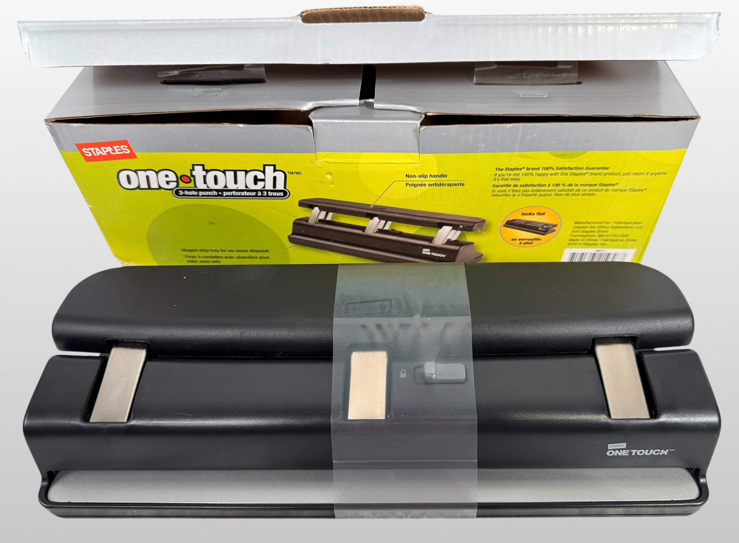 Staples One-Touch 3-hole punch model 26612 with 20-sheet capacity in open-box condition. Includes original packaging and locking flat design.