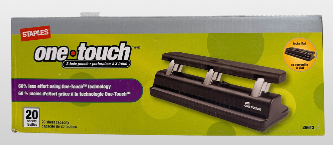 Staples One-Touch 3-hole punch model 26612 with 20-sheet capacity in open-box condition. Includes original packaging and locking flat design.