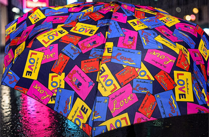 Vintage Yves Saint Laurent Love print folding umbrella in vibrant 80s pop-art colors. Rare collectible YSL fashion accessory in excellent condition.