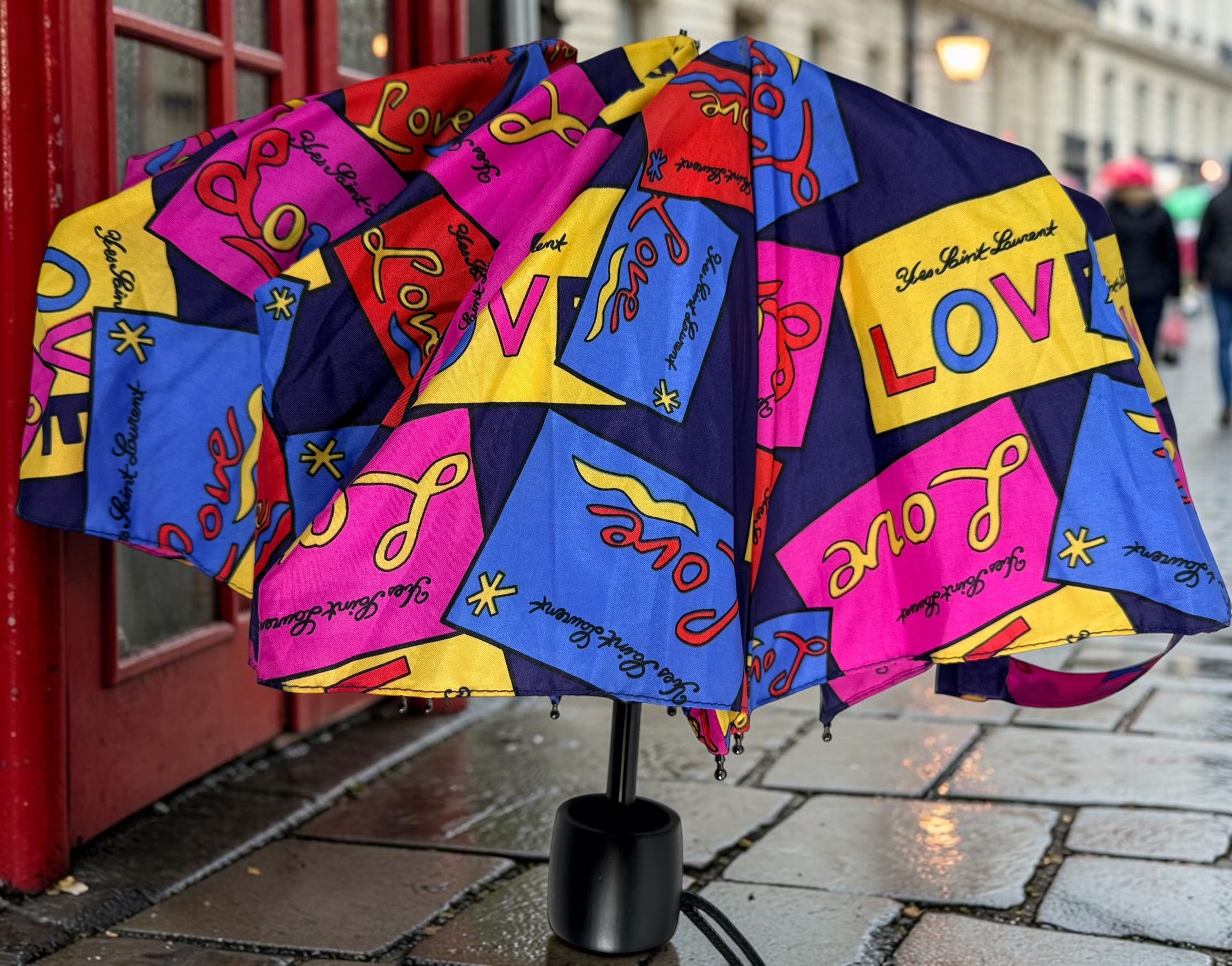 Vintage Yves Saint Laurent Love print folding umbrella in vibrant 80s pop-art colors. Rare collectible YSL fashion accessory in excellent condition.