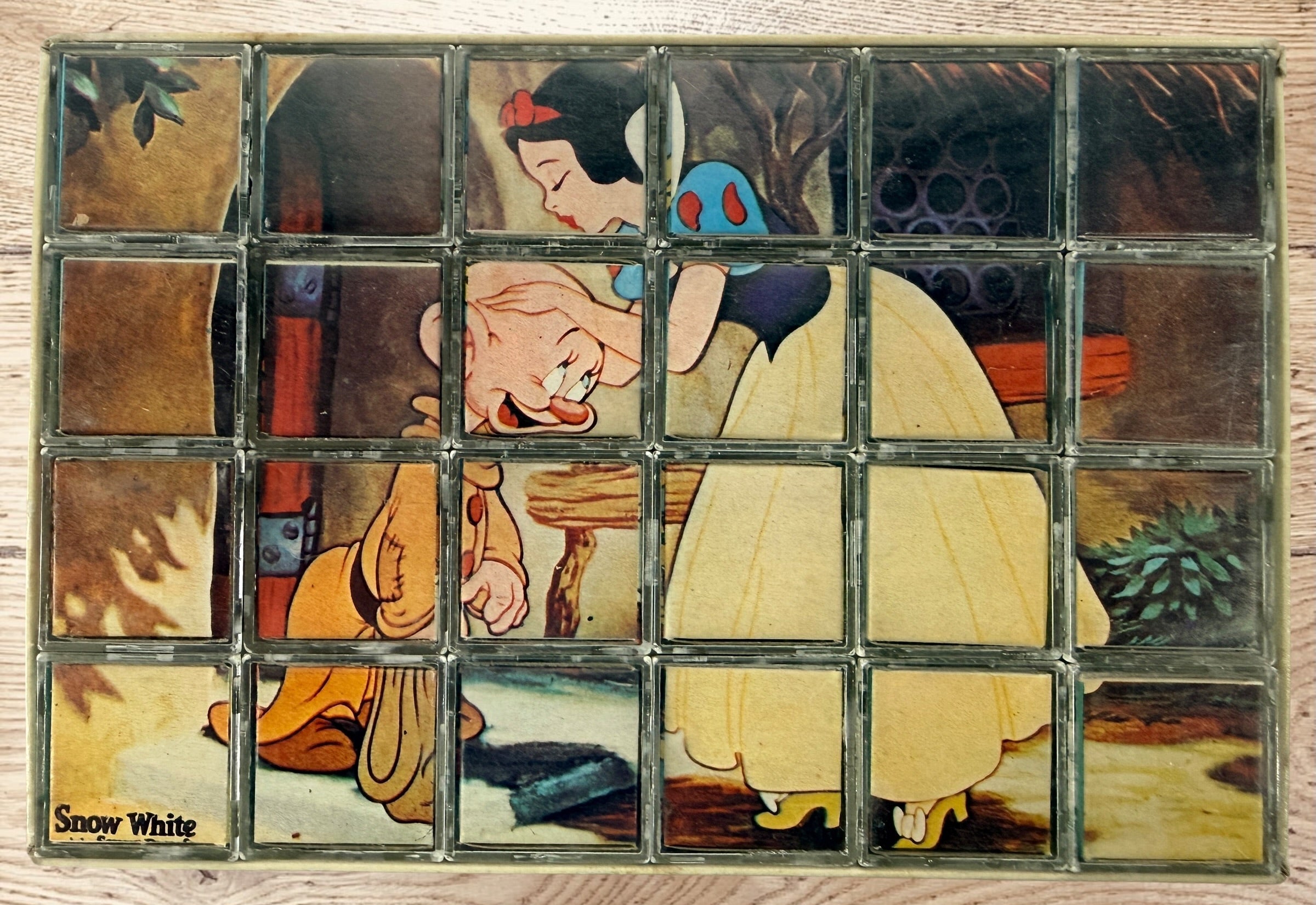 Vintage Walt Disney puzzle block set with original box featuring Snow White, Bambi, Mickey Mouse, Donald Duck, and Pinocchio scenes.