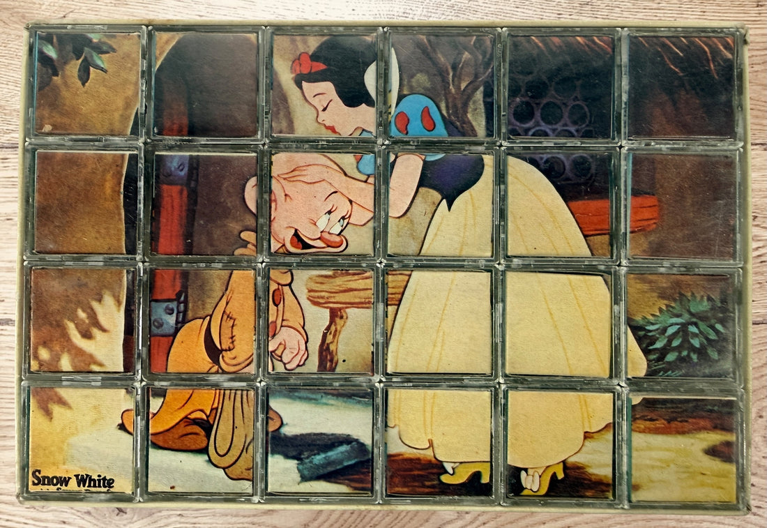 Vintage Walt Disney puzzle block set with original box featuring Snow White, Bambi, Mickey Mouse, Donald Duck, and Pinocchio scenes.