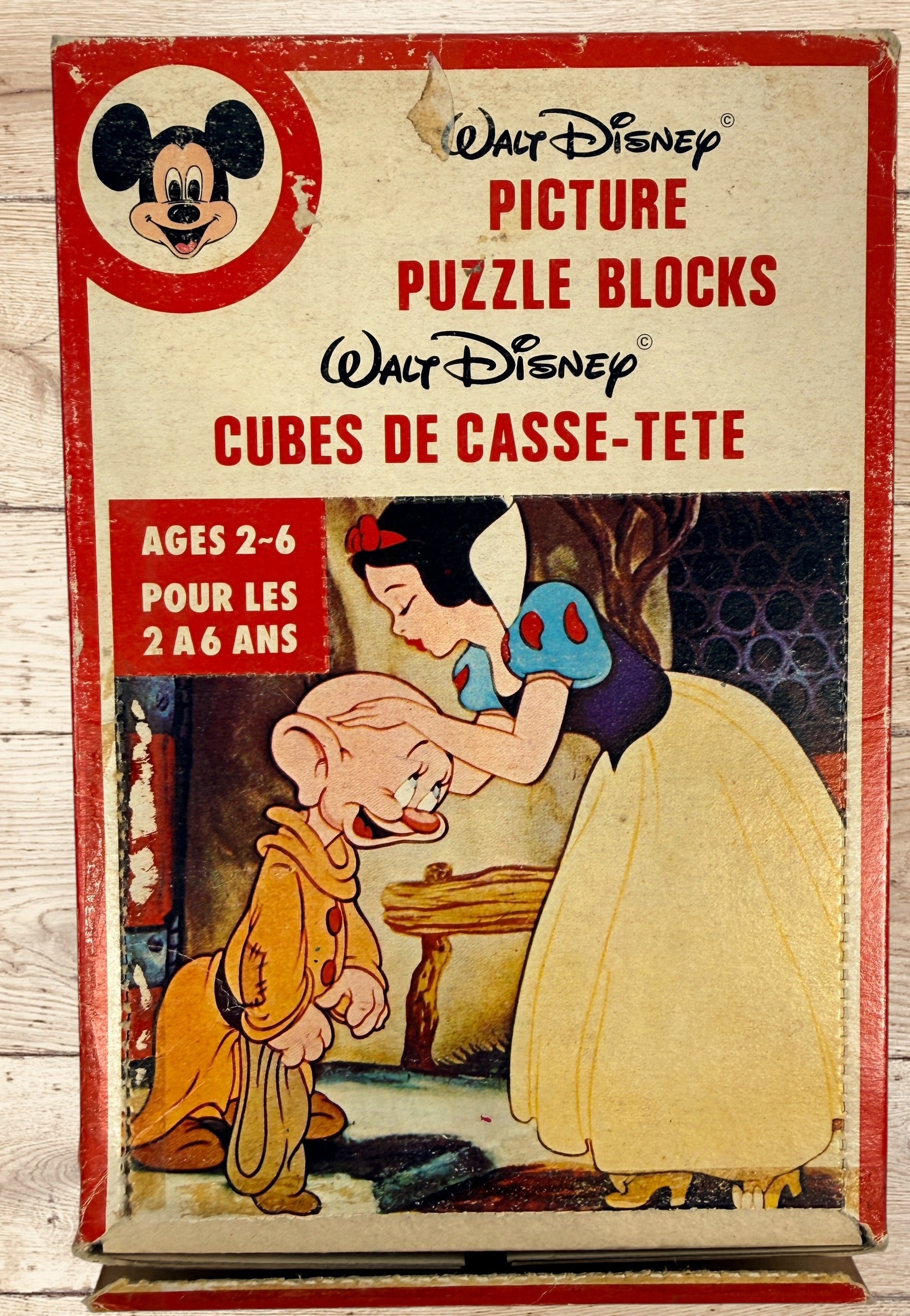 Vintage Walt Disney puzzle block set with original box featuring Snow White, Bambi, Mickey Mouse, Donald Duck, and Pinocchio scenes.