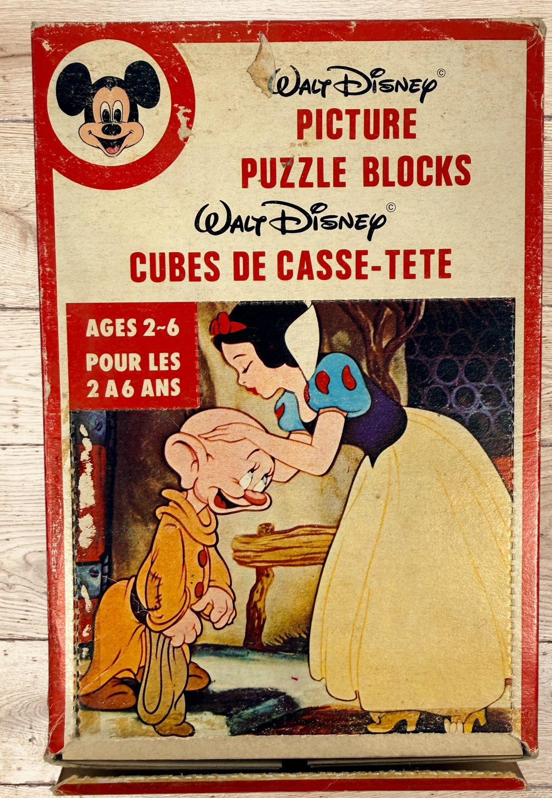 Vintage Walt Disney puzzle block set with original box featuring Snow White, Bambi, Mickey Mouse, Donald Duck, and Pinocchio scenes.