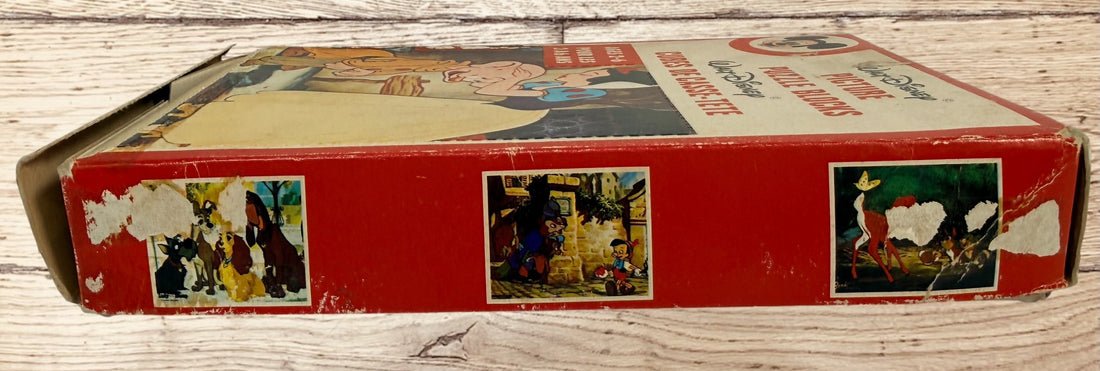 Vintage Walt Disney puzzle block set with original box featuring Snow White, Bambi, Mickey Mouse, Donald Duck, and Pinocchio scenes.