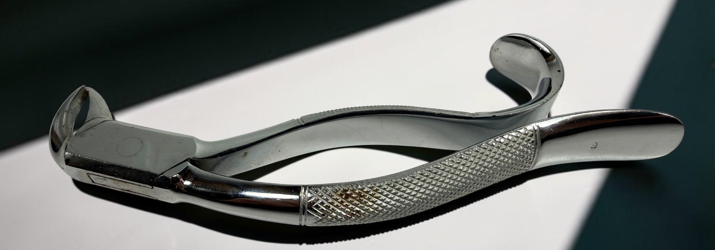 Vintage K. Scheerer German dental extraction forceps in chrome-plated steel. Medical antique collectible ideal for display, oddities, or prop use.
