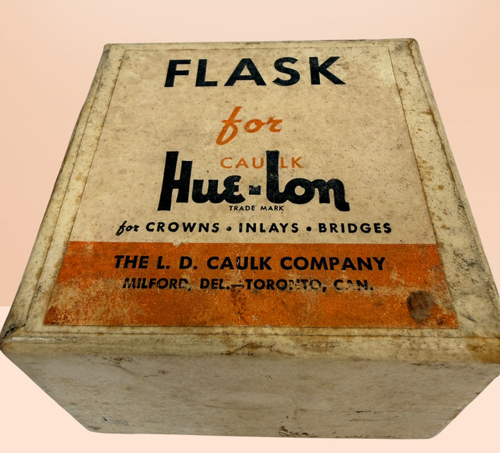 Vintage Caulk Hue-Lon dental casting flask brass mold with original box, collectible dental lab tool for crowns, bridges, and medical antique displays.