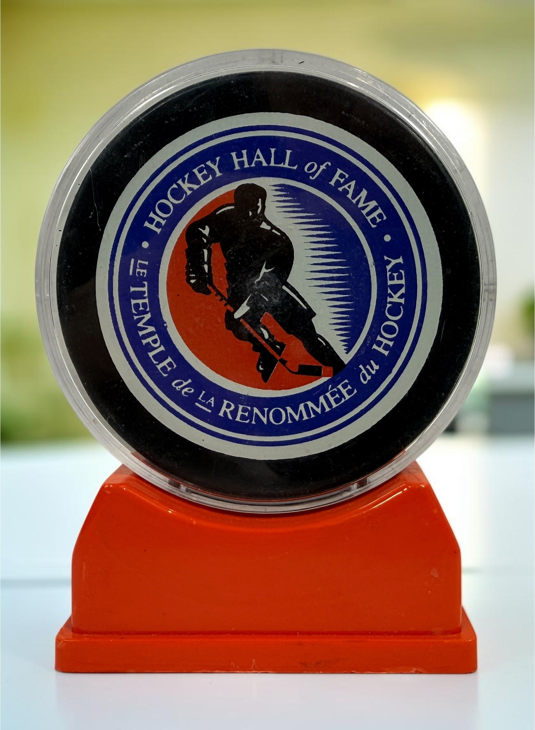 Vintage Hockey Hall of Fame autographed puck with multiple signatures and display case. Great Canadian hockey memorabilia collectible for fans.
