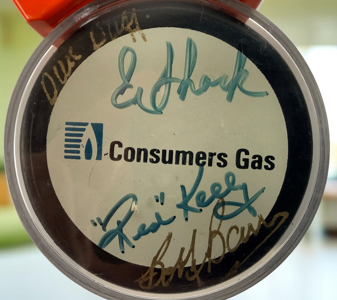 Vintage Hockey Hall of Fame autographed puck with multiple signatures and display case. Great Canadian hockey memorabilia collectible for fans.