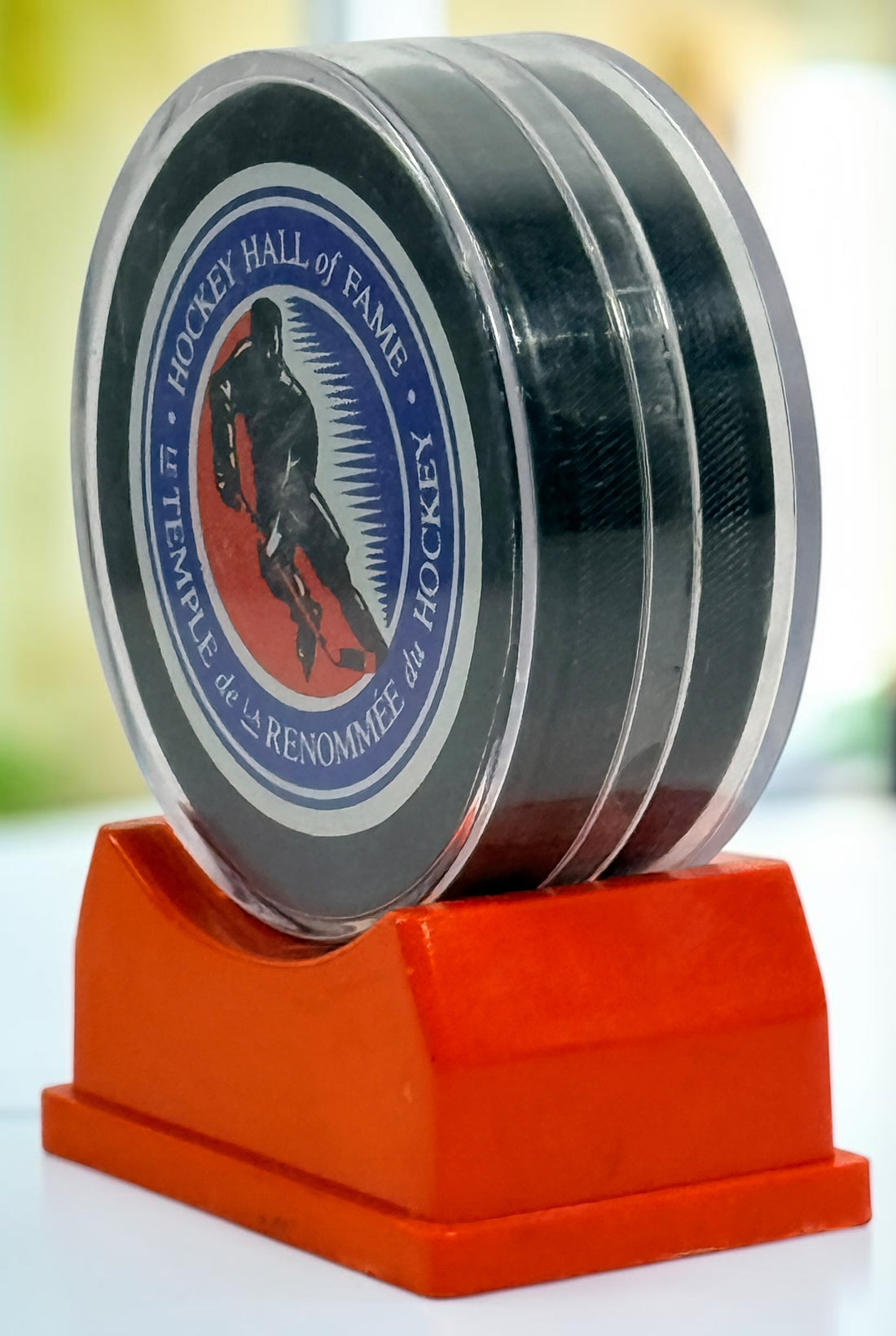 Vintage Hockey Hall of Fame autographed puck with multiple signatures and display case. Great Canadian hockey memorabilia collectible for fans.