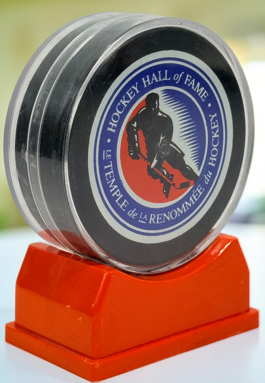 Vintage Hockey Hall of Fame autographed puck with multiple signatures and display case. Great Canadian hockey memorabilia collectible for fans.