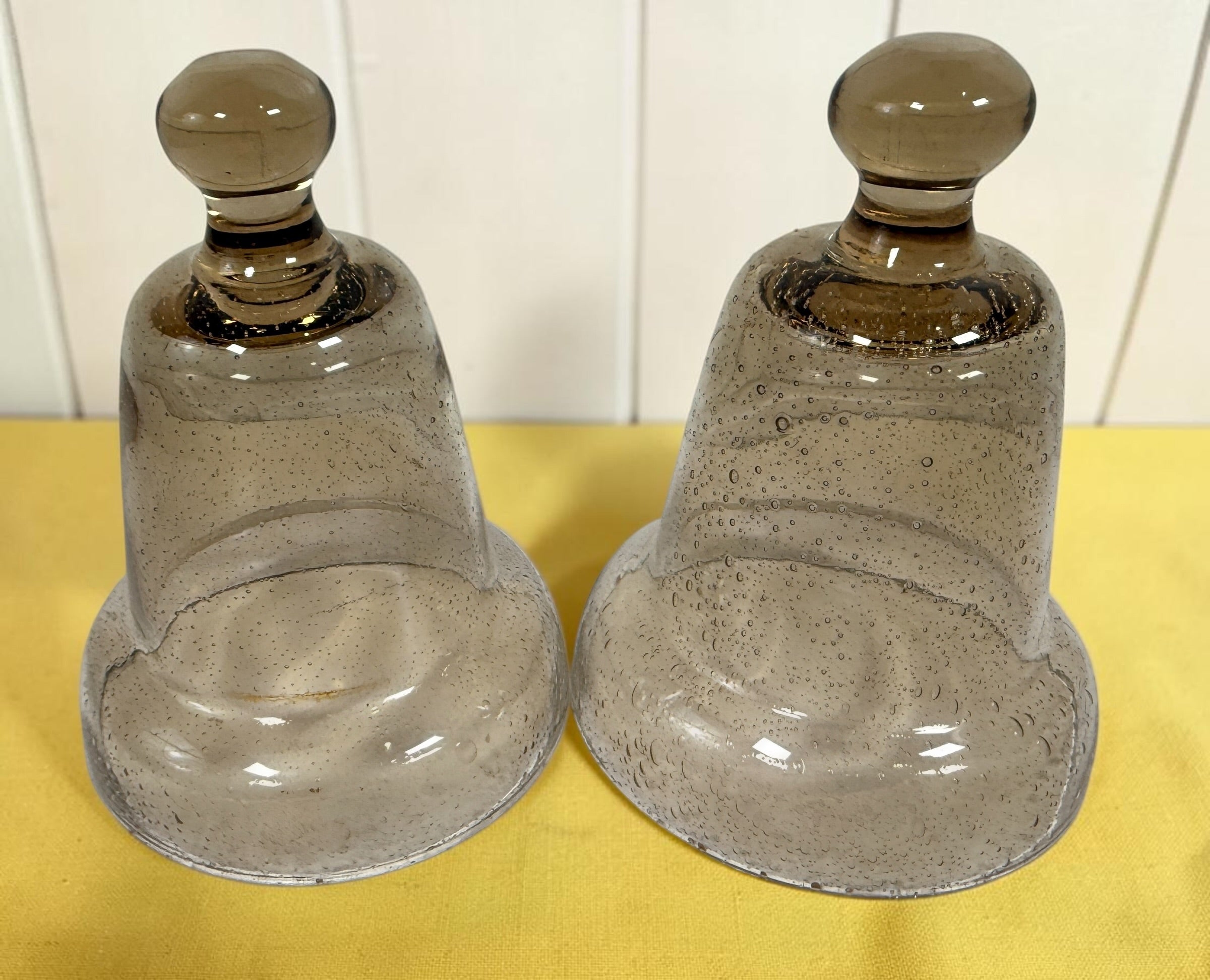 Vintage pair of mercury glass garden cloches with bell jar design and clear finials. Decorative plant covers ideal for garden or home display.