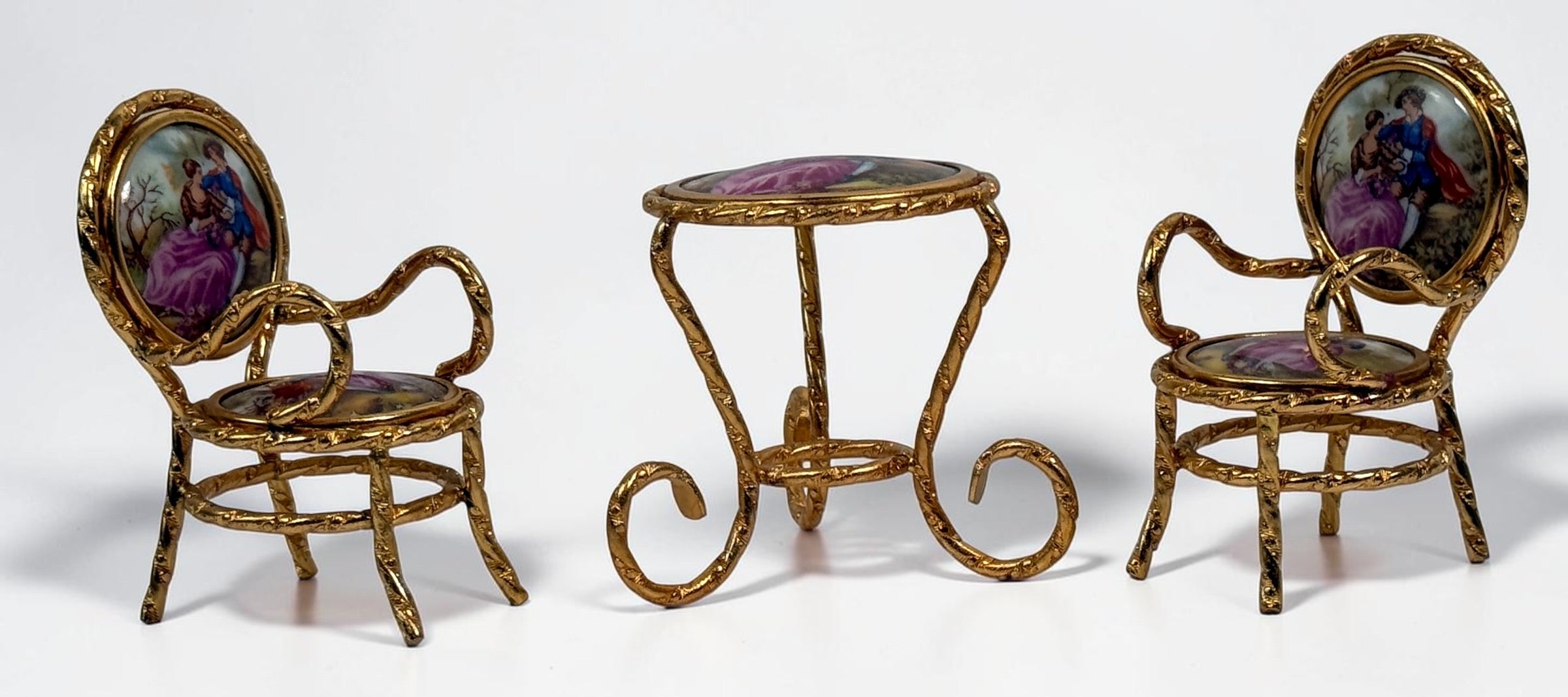 Vintage Limoges France miniature porcelain salon set with gilt metal chairs and table. Elegant French collectible featuring hand-painted romantic scenes.