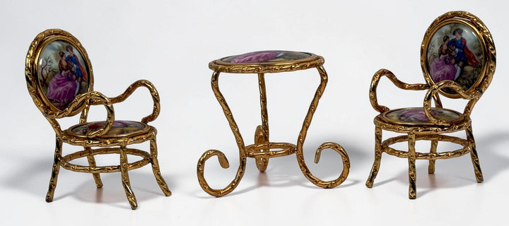Vintage Limoges France miniature porcelain salon set with gilt metal chairs and table. Elegant French collectible featuring hand-painted romantic scenes.