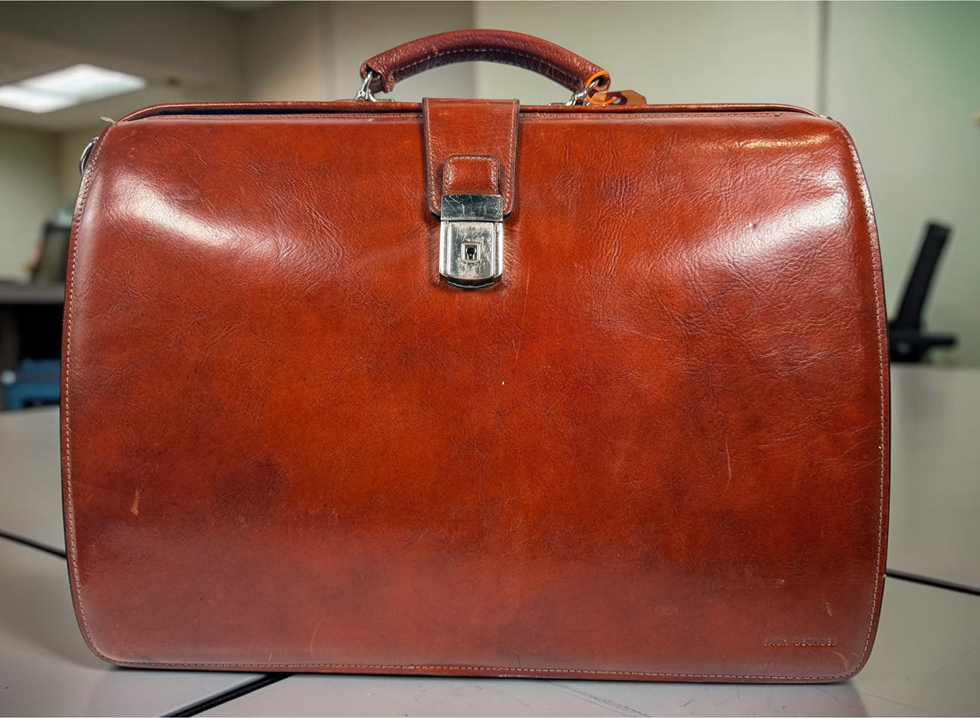 Authentic Jack Georges triple gusset leather briefcase in cognac brown featuring full-grain leather, locking closure, and spacious executive organization.