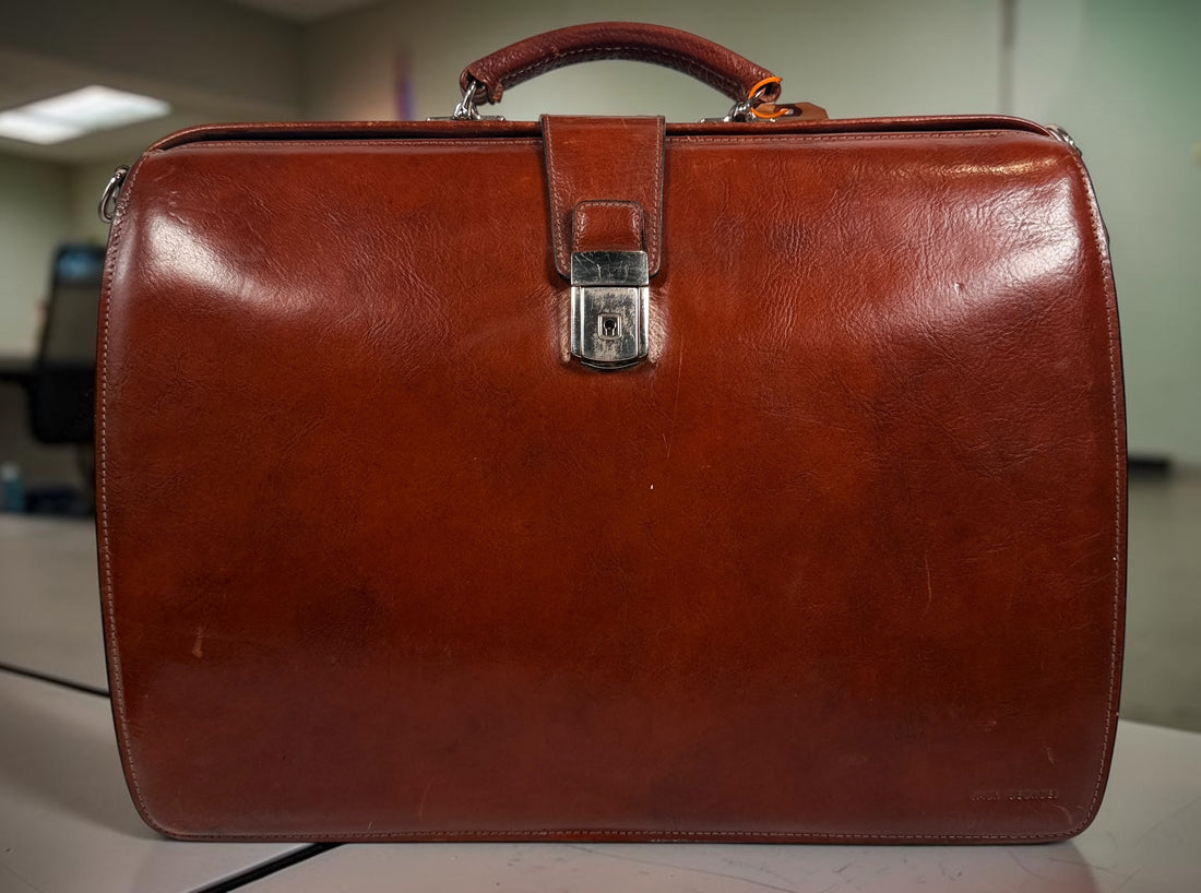 Authentic Jack Georges triple gusset leather briefcase in cognac brown featuring full-grain leather, locking closure, and spacious executive organization.