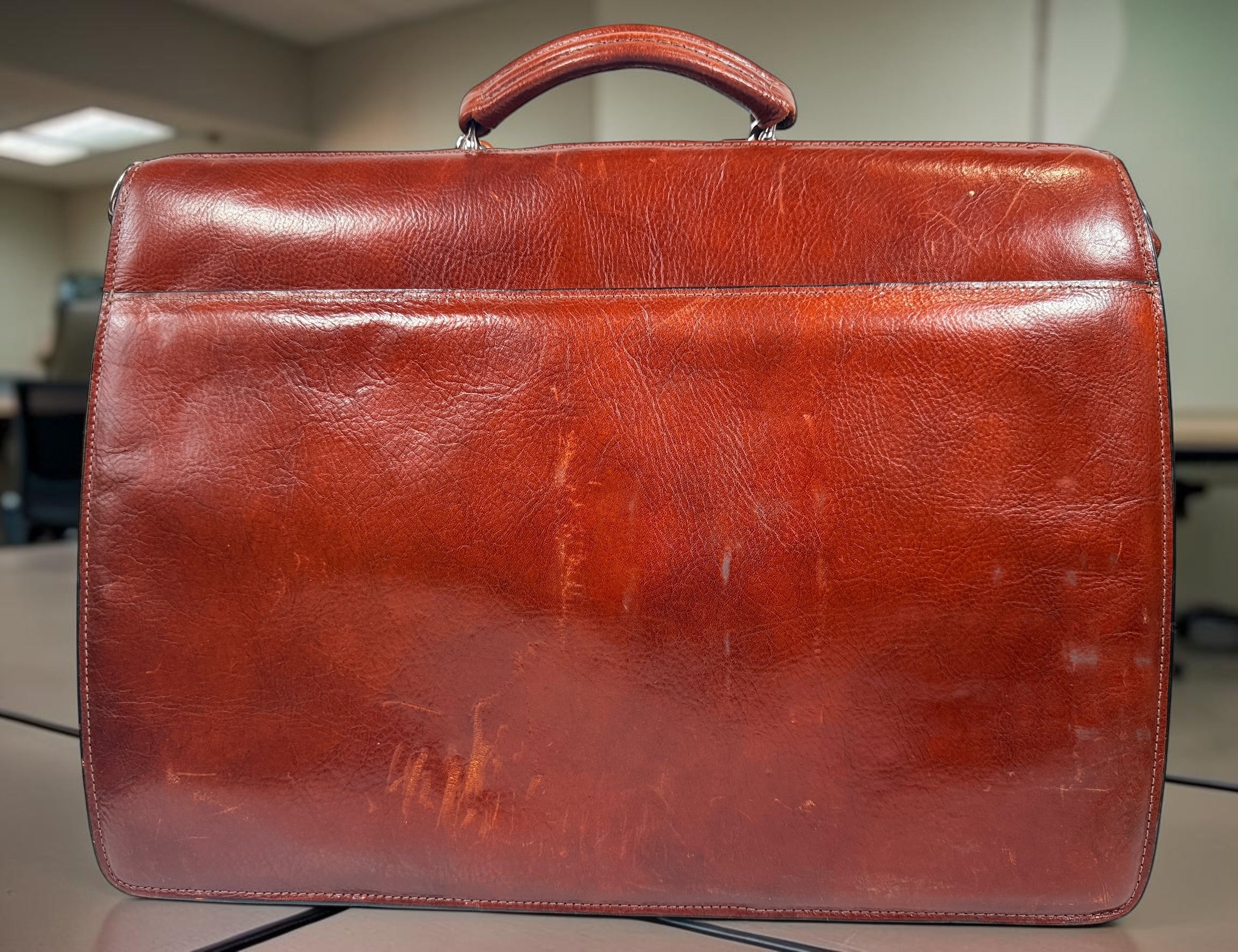 Authentic Jack Georges triple gusset leather briefcase in cognac brown featuring full-grain leather, locking closure, and spacious executive organization.
