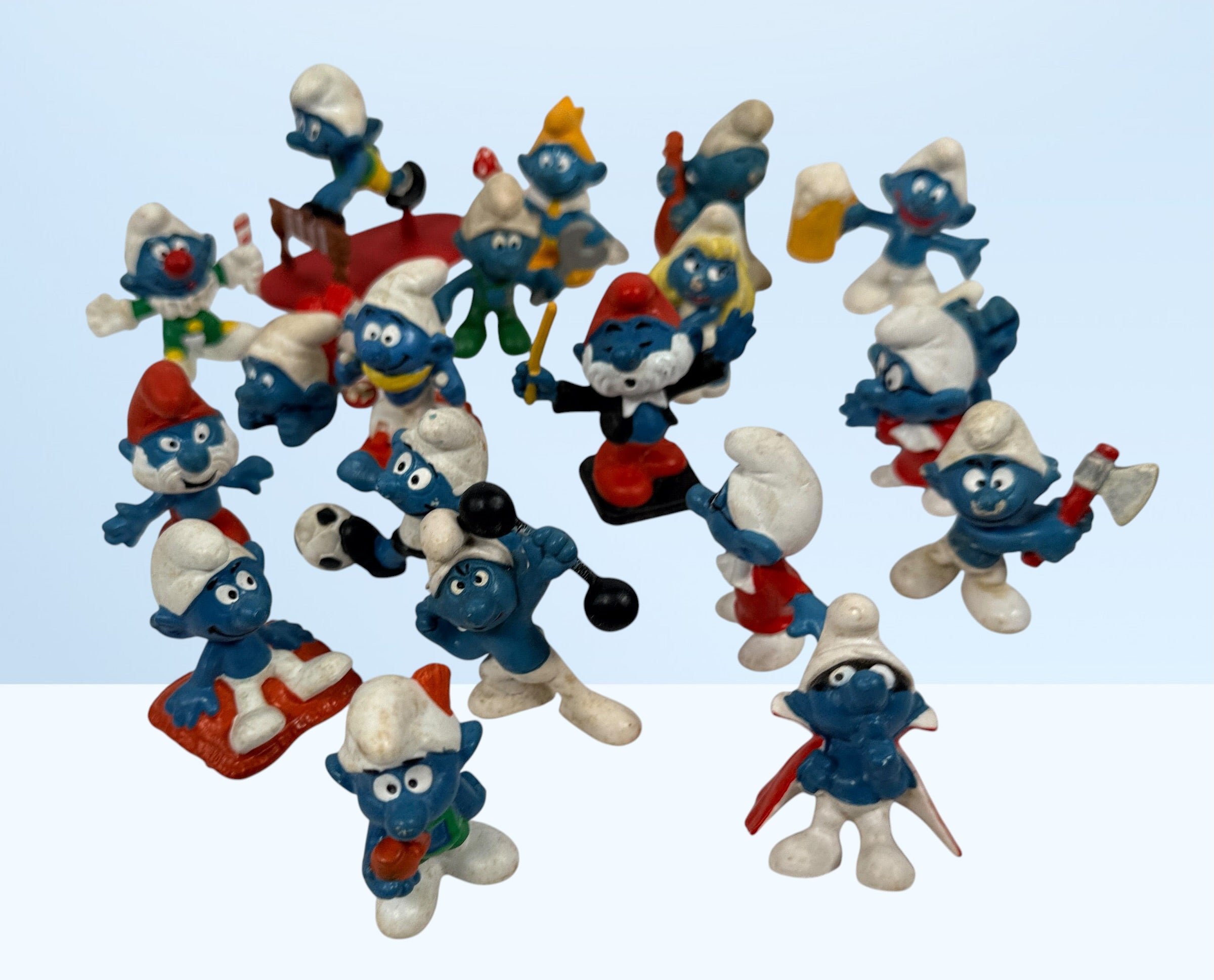 Vintage Peyo Smurf figure lot featuring 20 authentic West Germany Schleich PVC figures from the 1980s. Classic collectible characters in fair to good condition.