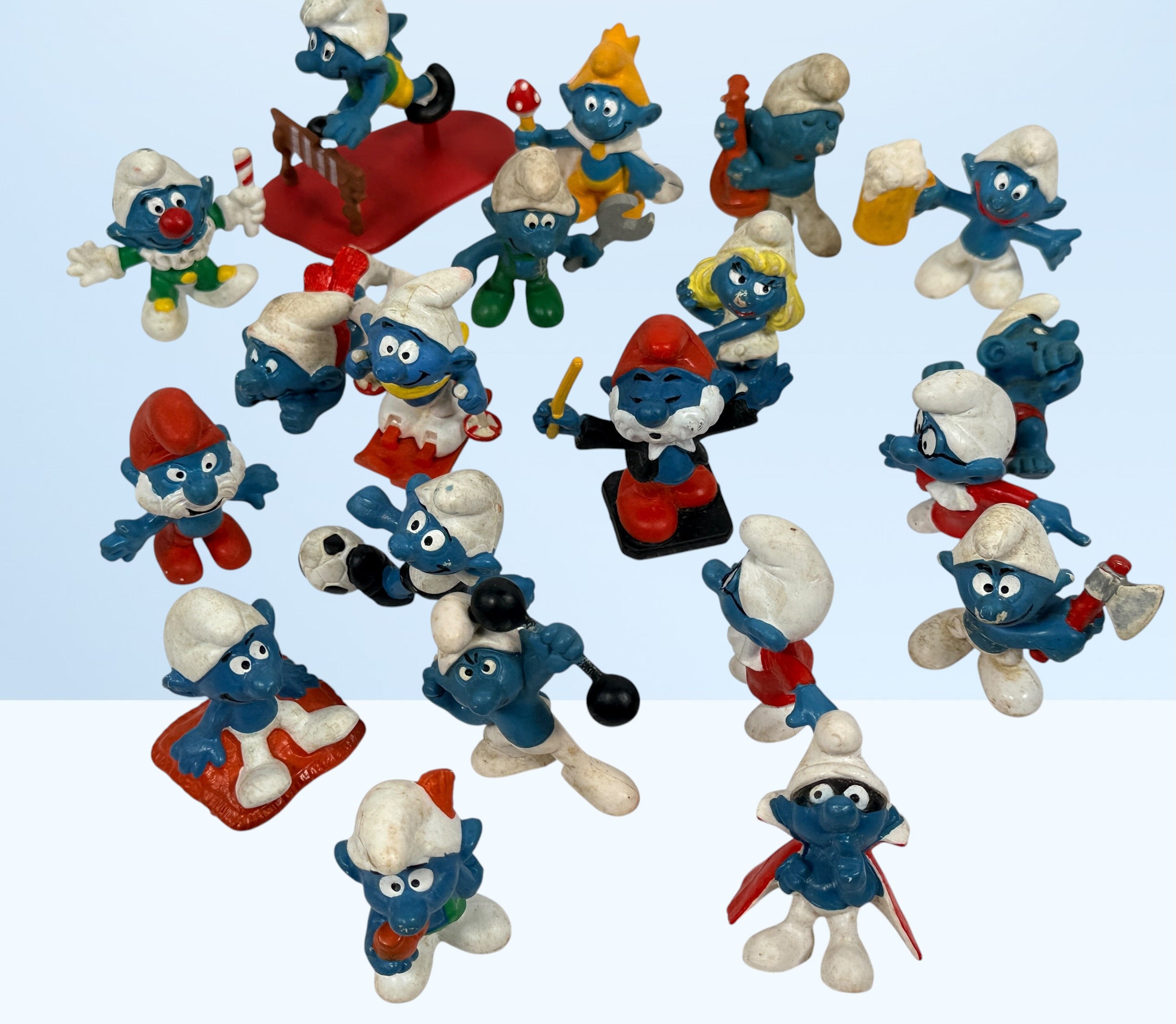 Vintage Peyo Smurf figure lot featuring 20 authentic West Germany Schleich PVC figures from the 1980s. Classic collectible characters in fair to good condition.