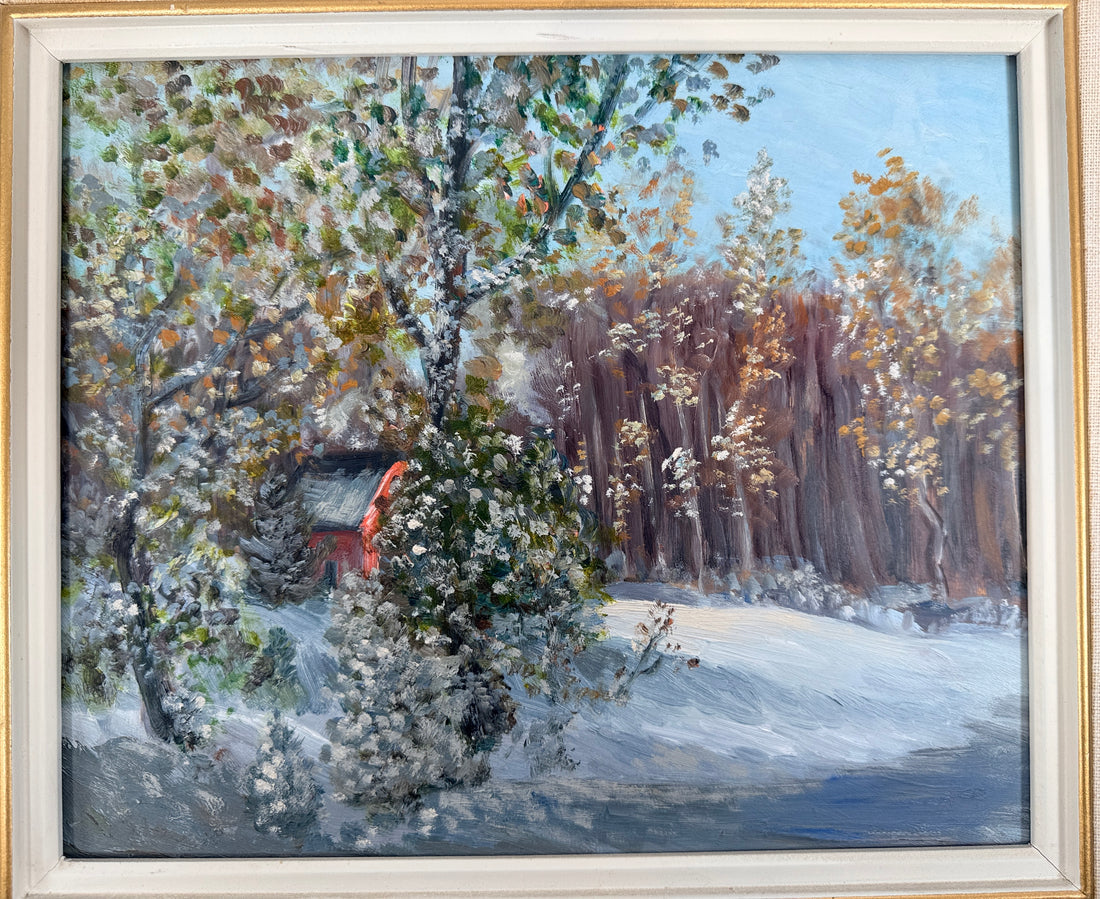 Framed painting of a snowy landscape with trees and a small building.