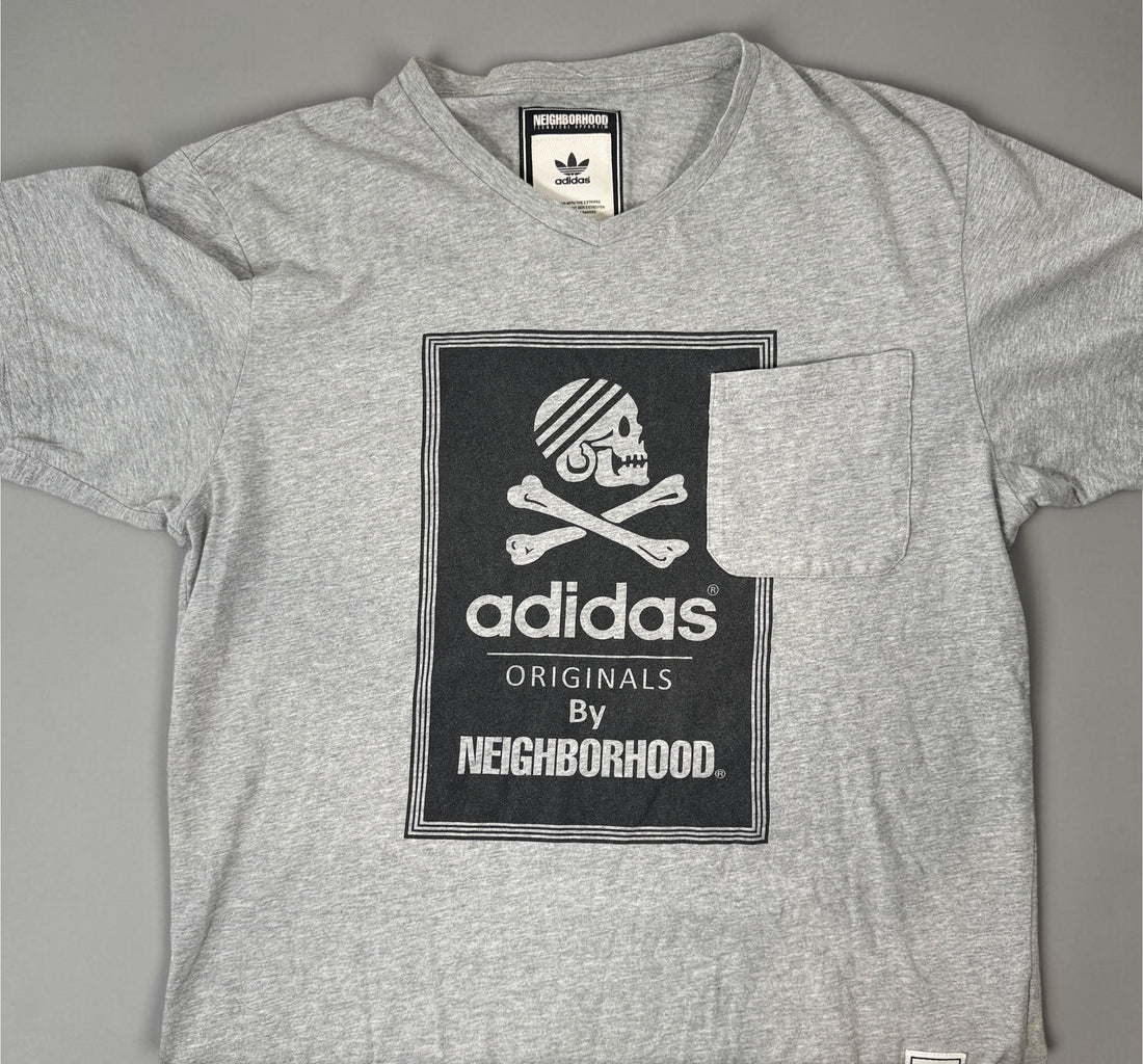 Authentic Adidas Originals x Neighborhood graphic T-shirt in size medium featuring skull artwork, V-neck styling, and collectible Japanese streetwear appeal.
