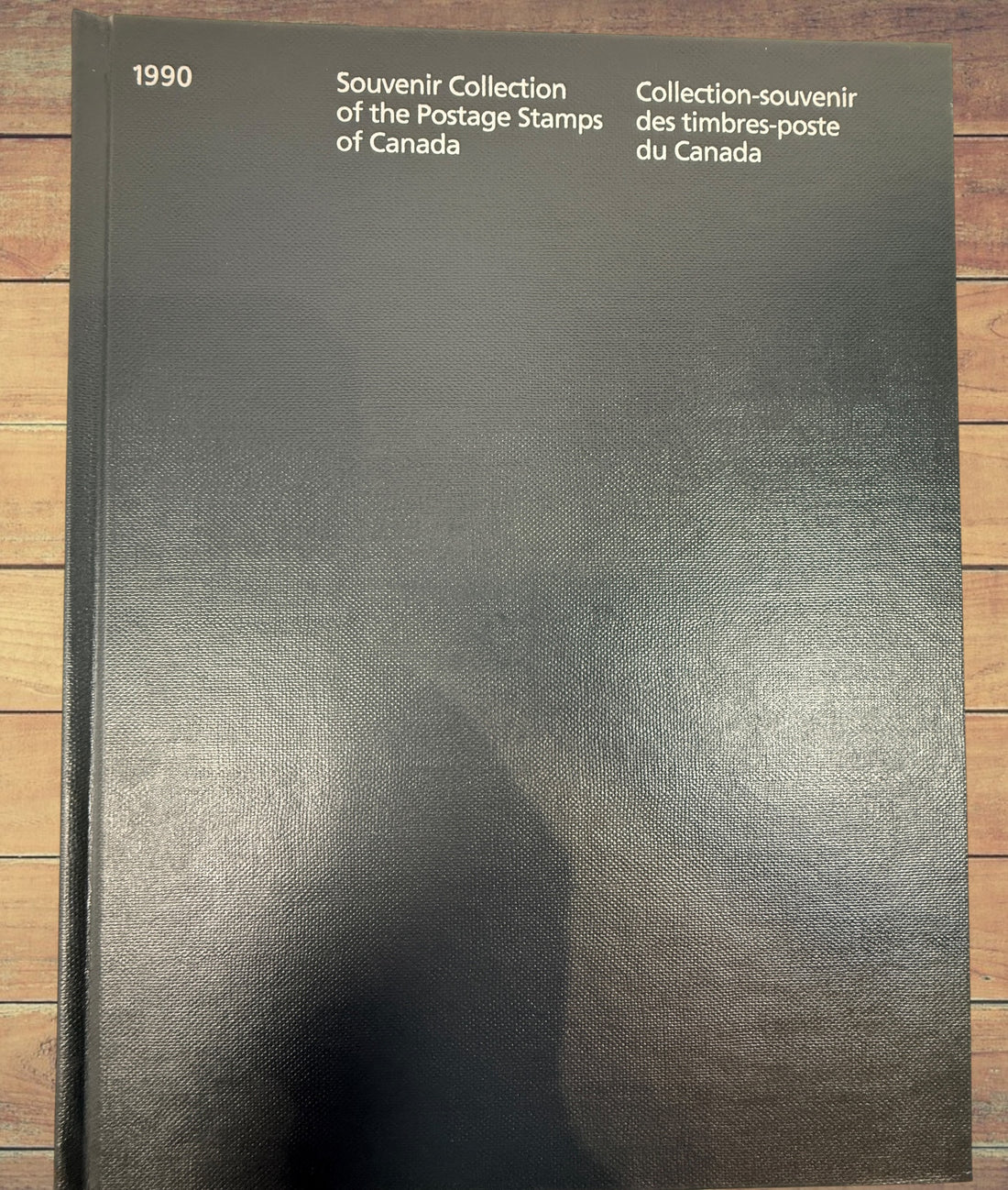 Complete Canada Post 1990 Souvenir Collection album featuring original Canadian stamps, bilingual content, historical notes, and philatelic reference material.