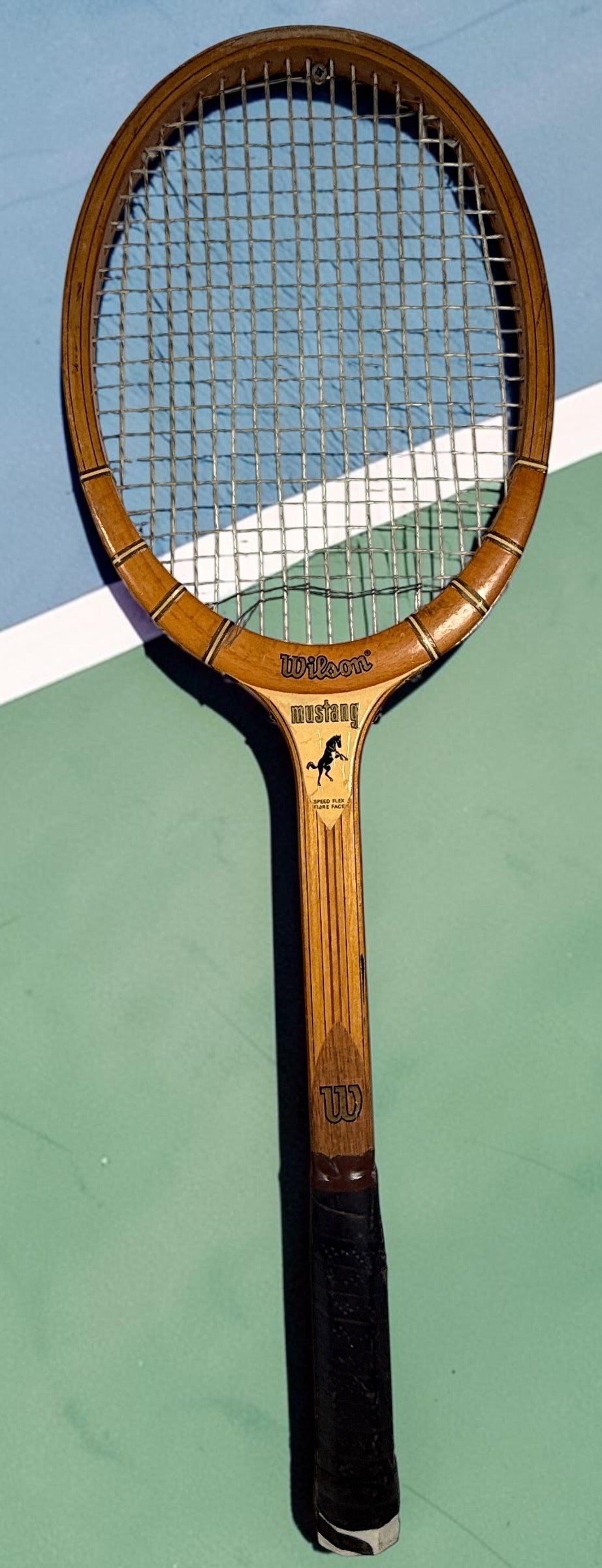 Vintage Wilson Mustang wooden tennis racket with Speed Flex Fibre Face construction. Classic mid-century tennis memorabilia and decorative sports display piece.