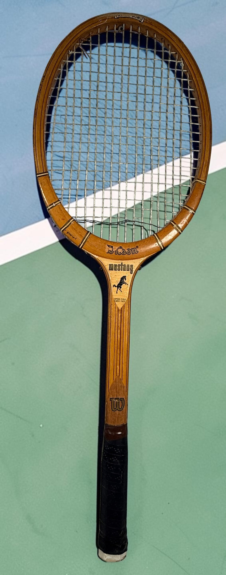 Vintage Wilson Mustang wooden tennis racket with Speed Flex Fibre Face construction. Classic mid-century tennis memorabilia and decorative sports display piece.