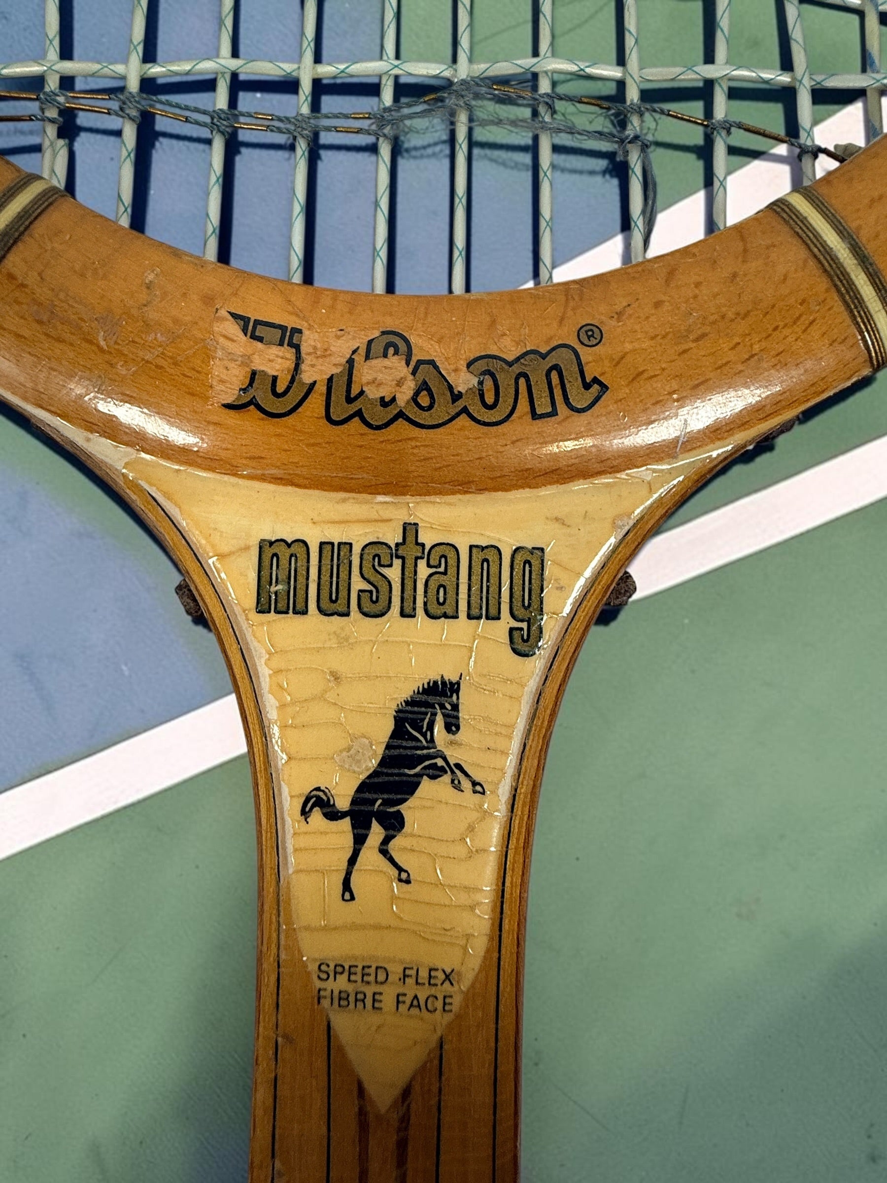 Vintage Wilson Mustang wooden tennis racket with Speed Flex Fibre Face construction. Classic mid-century tennis memorabilia and decorative sports display piece.