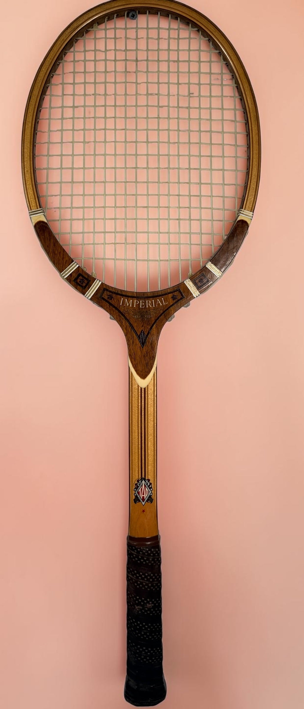 Vintage T.A. Davis Imperial wooden tennis racket made in the USA. Classic laminated hardwood racket with original grip and strings, ideal for collectors and décor.