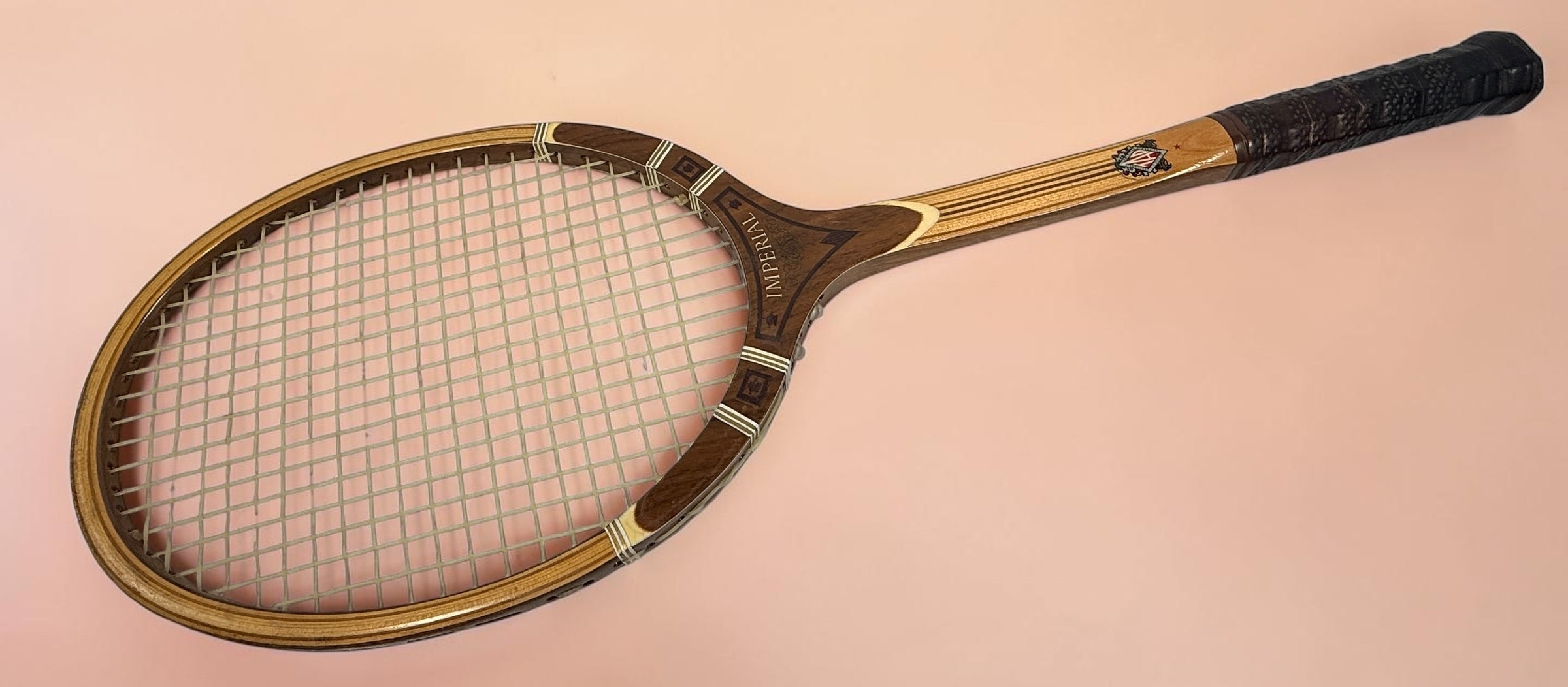 Vintage T.A. Davis Imperial wooden tennis racket made in the USA. Classic laminated hardwood racket with original grip and strings, ideal for collectors and décor.