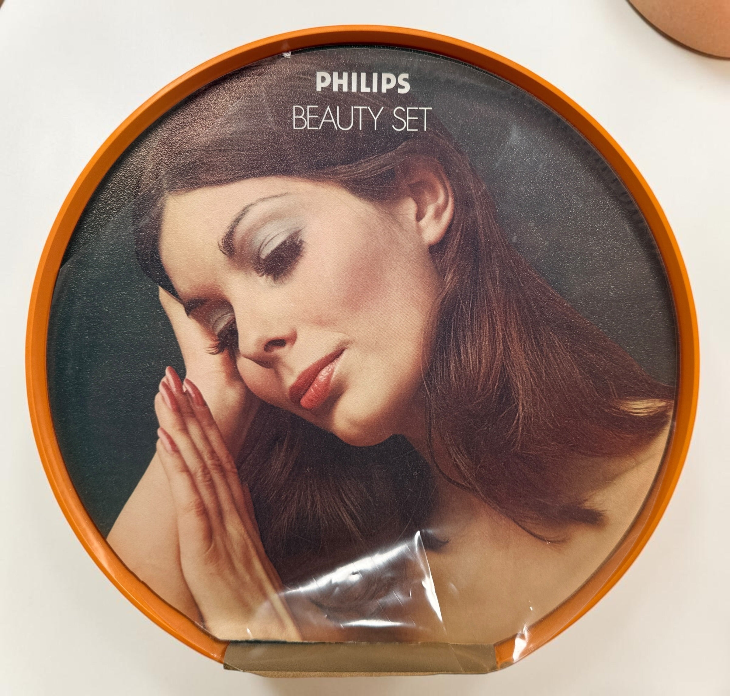 Vintage Philips Beauty Set from the early 1970s with original orange case, grooming accessories, paperwork, and Space Age styling. Complete collectible kit.