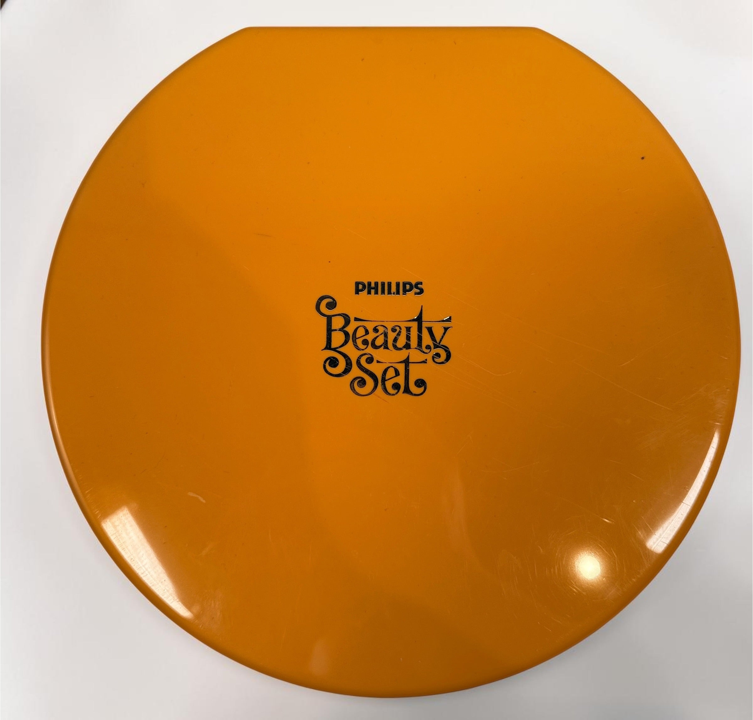 Vintage Philips Beauty Set from the early 1970s with original orange case, grooming accessories, paperwork, and Space Age styling. Complete collectible kit.