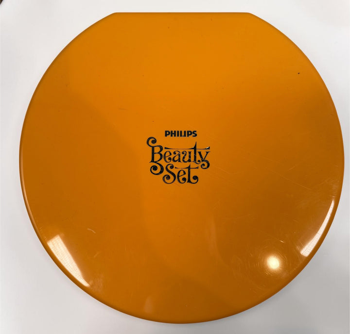 Vintage Philips Beauty Set from the early 1970s with original orange case, grooming accessories, paperwork, and Space Age styling. Complete collectible kit.