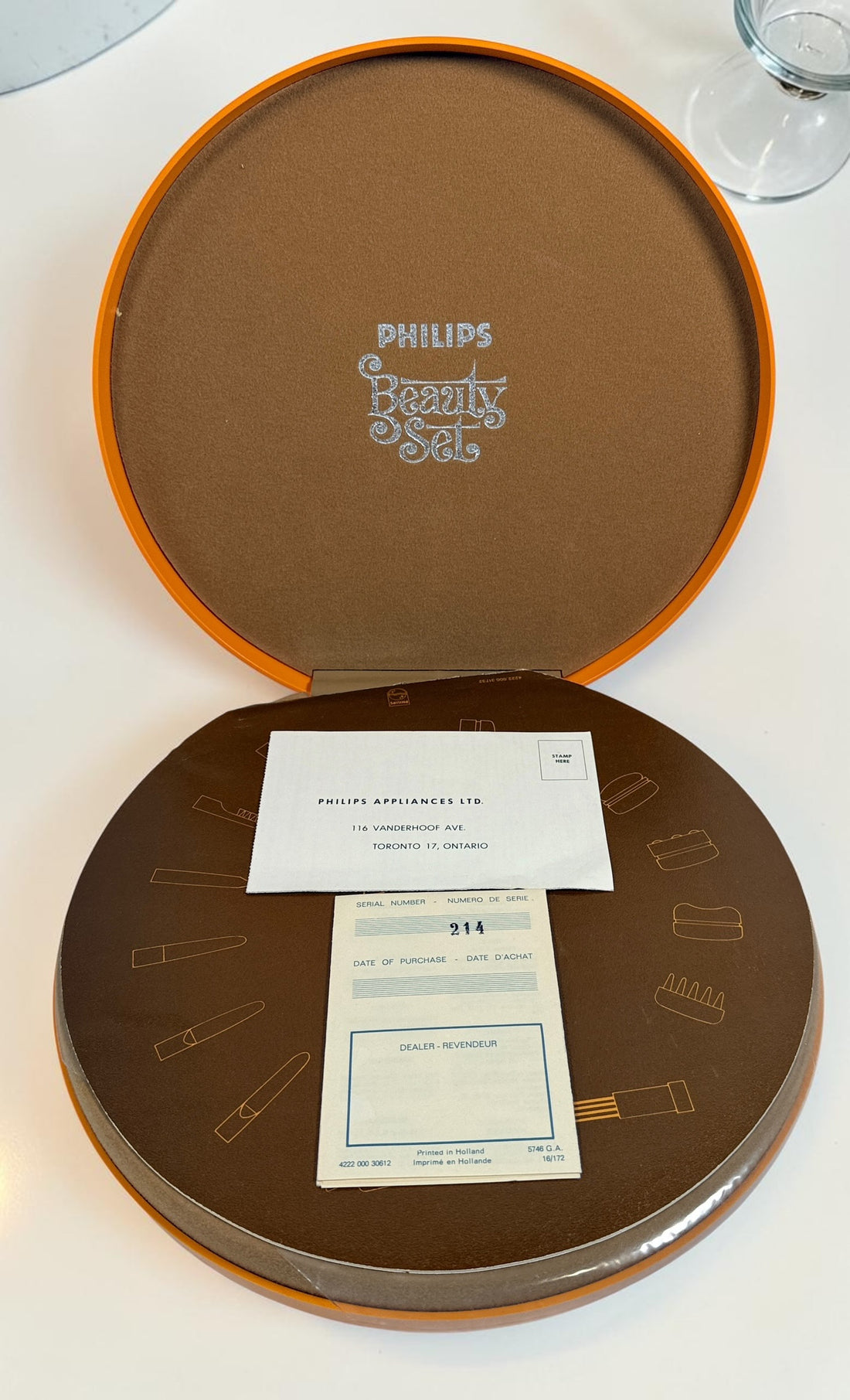 Vintage Philips Beauty Set from the early 1970s with original orange case, grooming accessories, paperwork, and Space Age styling. Complete collectible kit.